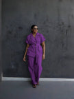 Purple belted lapel pantsuit with front flap pockets and tapered trousers