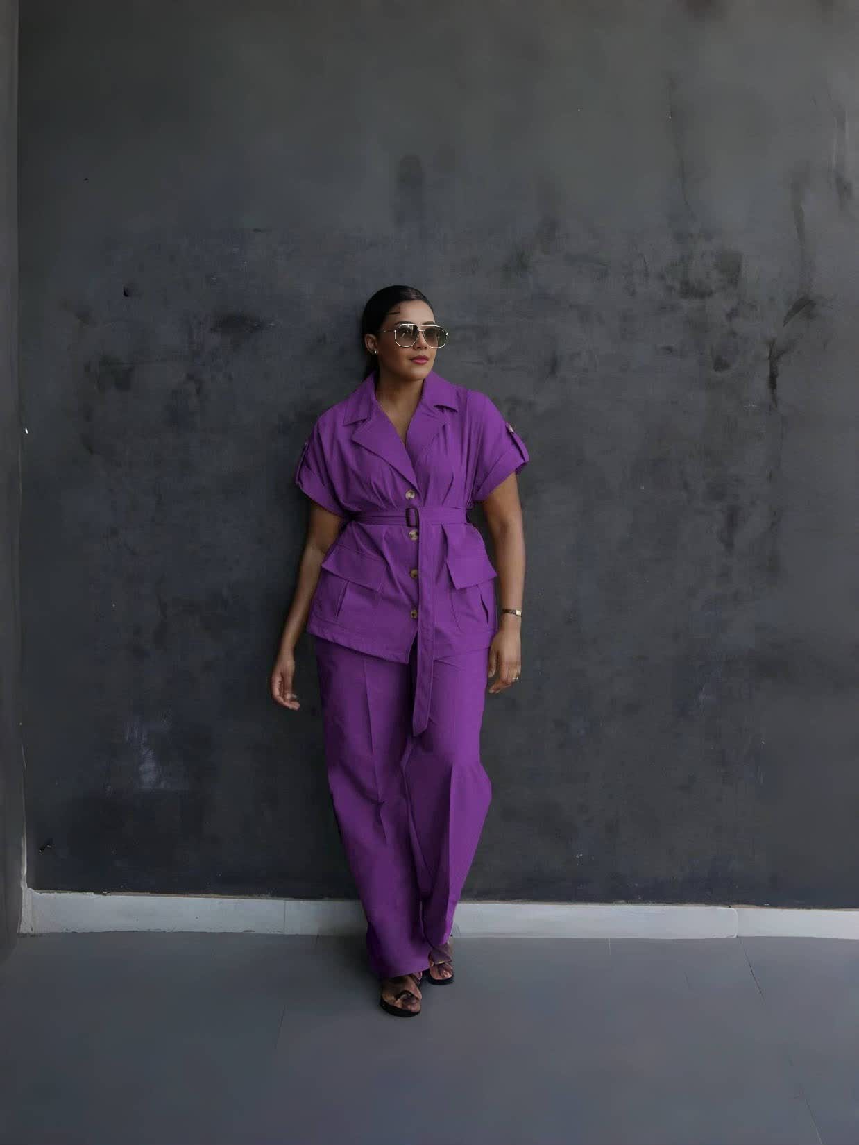Purple belted lapel pantsuit with front flap pockets and tapered trousers