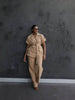 Nude belted lapel pantsuit with short sleeves and matching straight-leg trousers