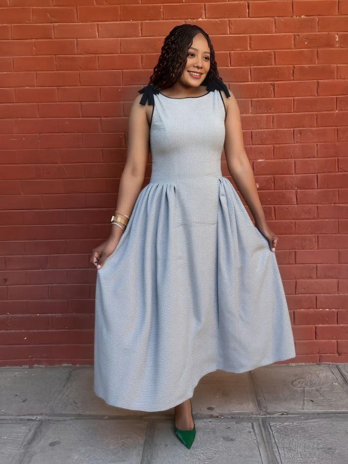 Light blue pleated midi dress with sleeveless bodice and elastic waist, full skirt