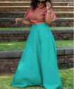 Geometric twin set: pink patterned crop top and turquoise flared maxi skirt