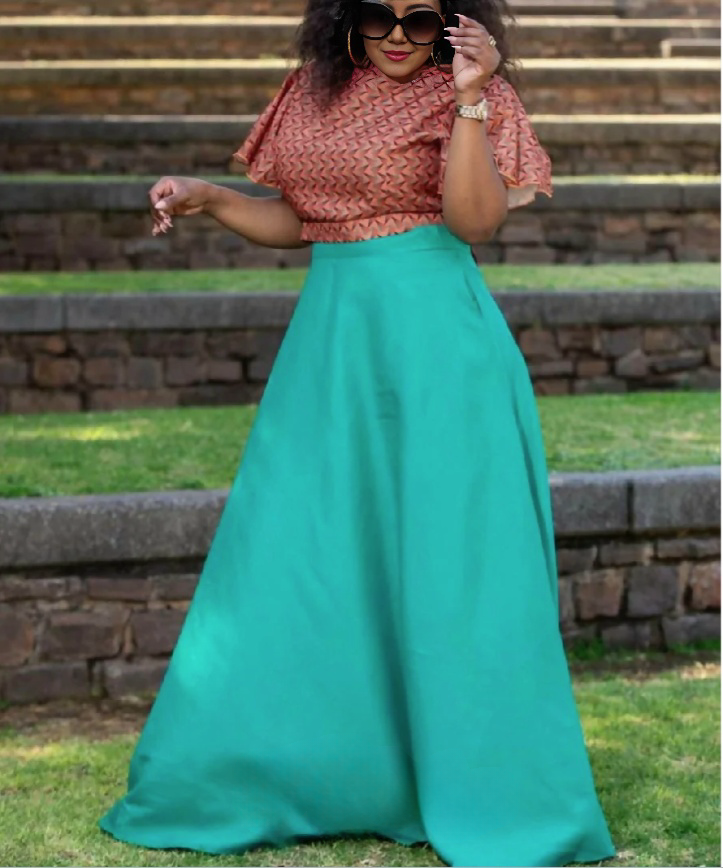 Geometric twin set: pink patterned crop top and turquoise flared maxi skirt