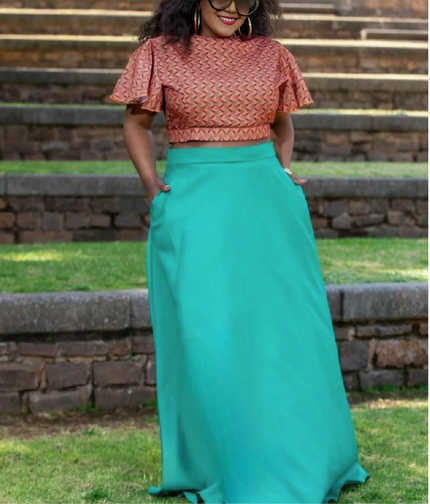 Geometric twin set: pink patterned crop top and turquoise high-waist flared maxi skirt