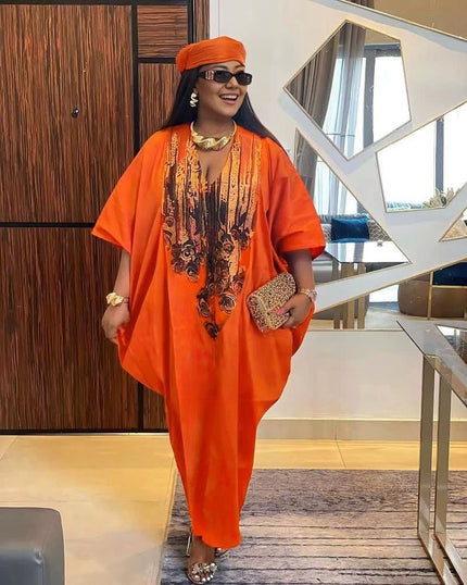 Orange-red kaftan dress with black floral front panel, loose caftan sleeves