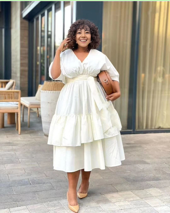 White tiered midi dress with puff sleeves and cinched adjustable waist