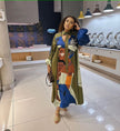 Printed long sleeve maxi dress in green with colorful face artwork and long skirt