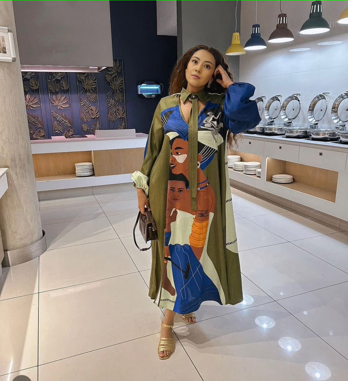 Printed long sleeve maxi dress in green with colorful face artwork and long skirt
