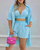 Light blue three-piece twin set with button-front crop top, drawstring shorts, open shirt