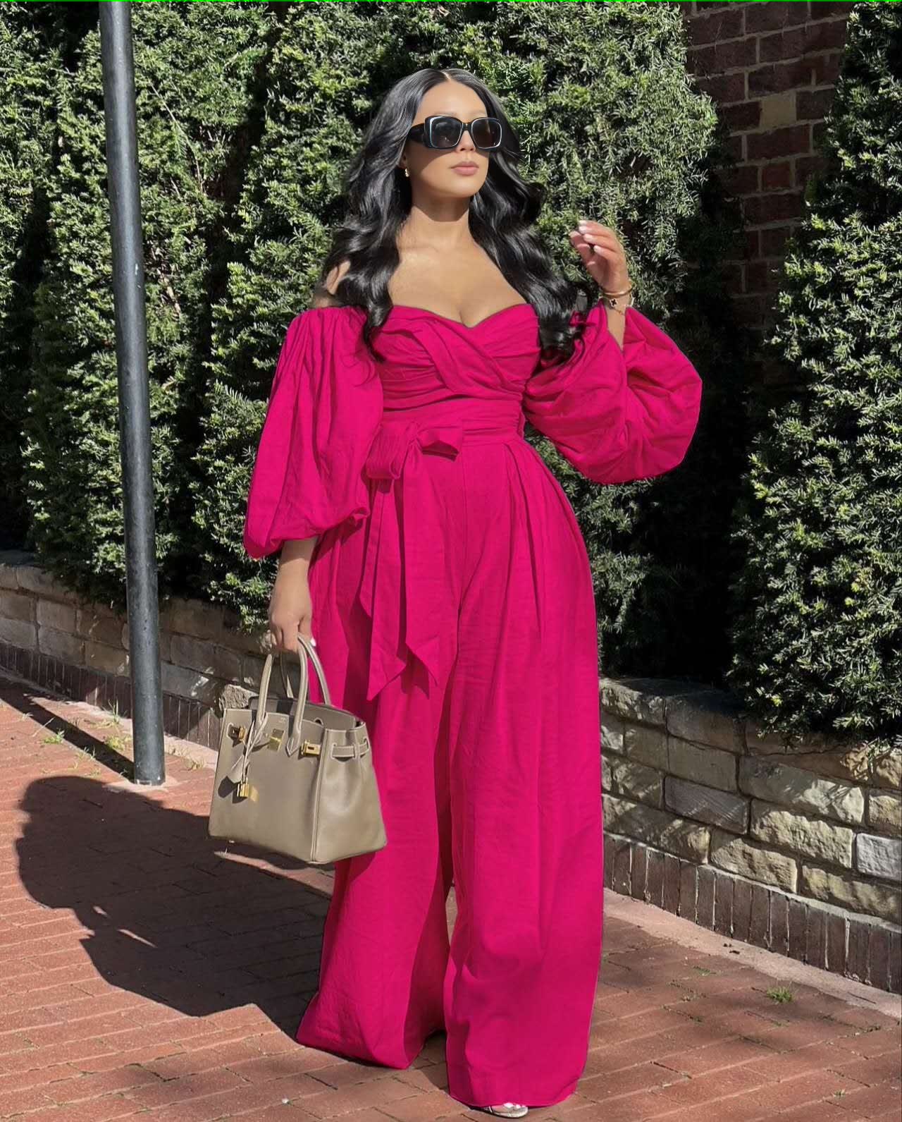 Deep-pink off-shoulder puff-sleeve jumpsuit, ruched bodice, wide-leg trousers