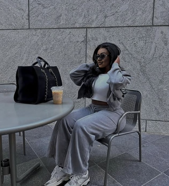 Grey zip jacket and tapered pants loungewear set, hands on head