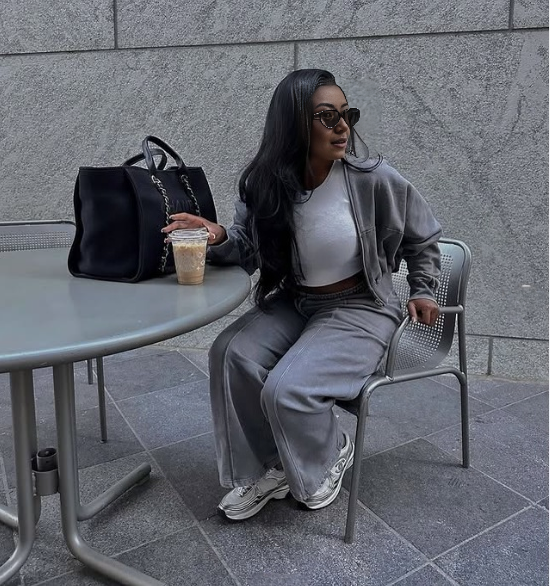 Grey zip jacket and tapered pants loungewear set, seated