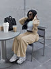 Tan zip jacket and tapered pants loungewear set, seated