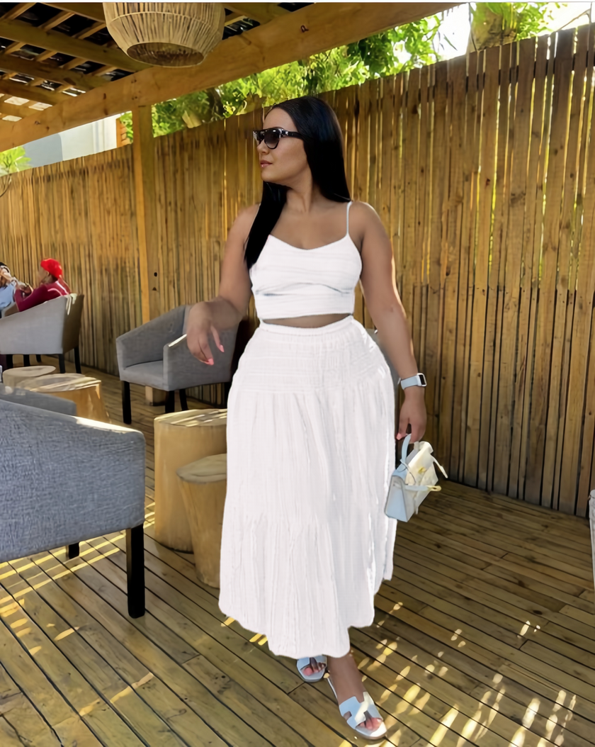 White pleated maxi skirt and spaghetti-strap crop top set with tiered ruffles