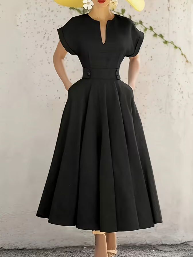 Black A-line midi dress with pleated skirt, short sleeves, keyhole neckline, waist buttons