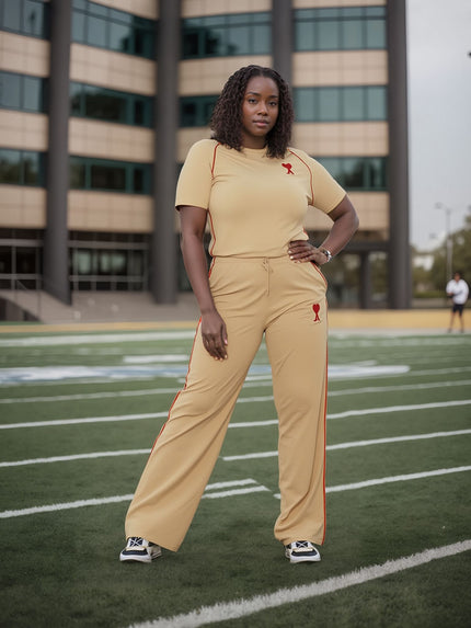 Tan wide-leg stretch waist pants with red logo on leg.