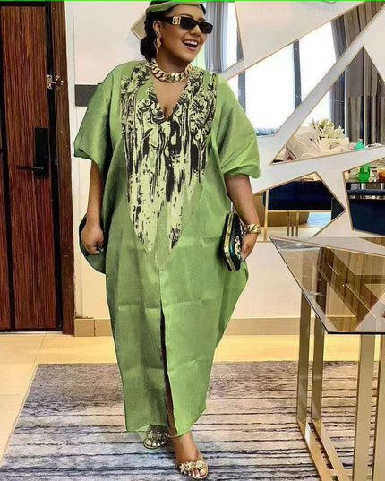 Green kaftan dress with black floral print, wide short sleeves and V neckline