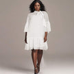 White pleated midi dress with puff sleeves and ruffle hem