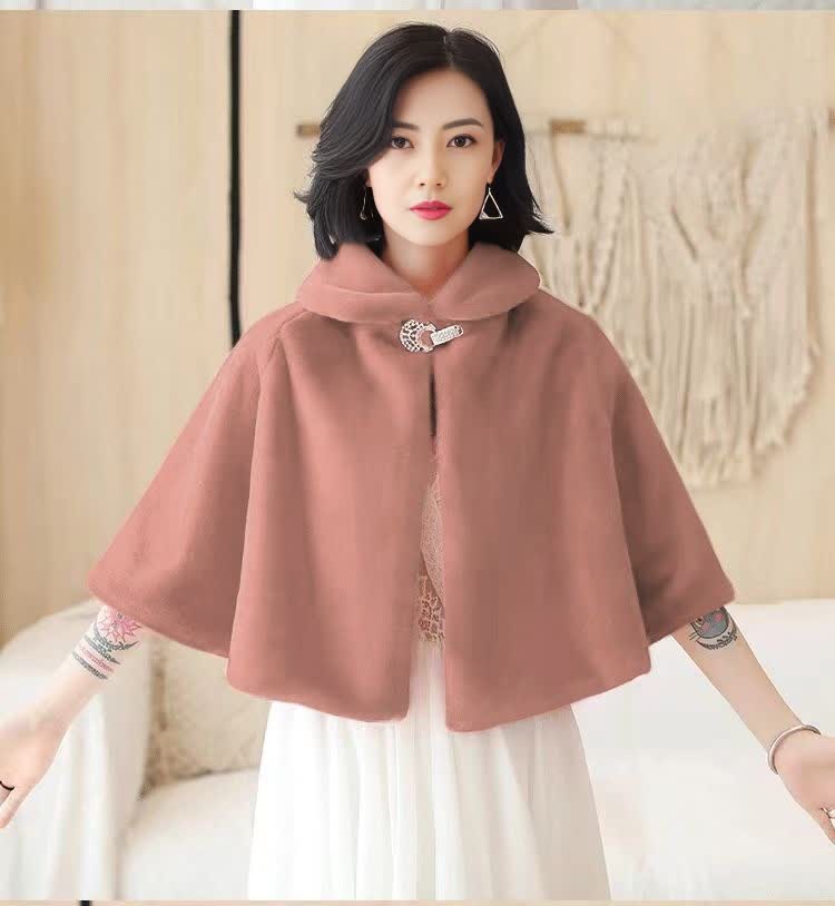 Pink cape with buttoned bow accent at collar, loose poncho silhouette