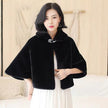 Black faux-fur cape with buttoned bow accent at collar