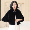 Black faux-fur cape with buttoned bow accent at collar