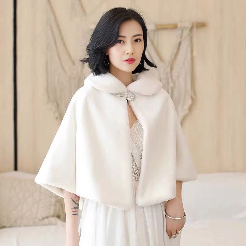 White cape with buttoned bow accent at collar, draped poncho style