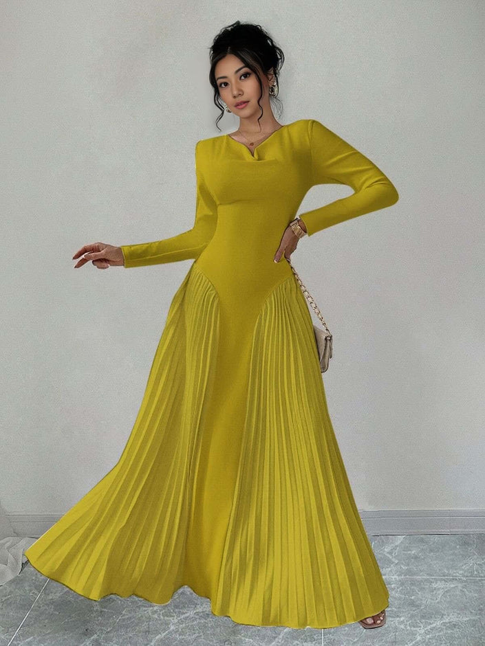 Yellow pleated maxi dress with long sleeves and fitted waist, flowing flared skirt