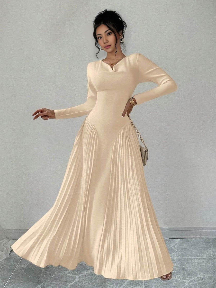 Nude pleated maxi dress with long sleeves and fitted waist, flared pleats