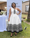 One-shoulder white midi dress with bold black striped hem and black vertical trim