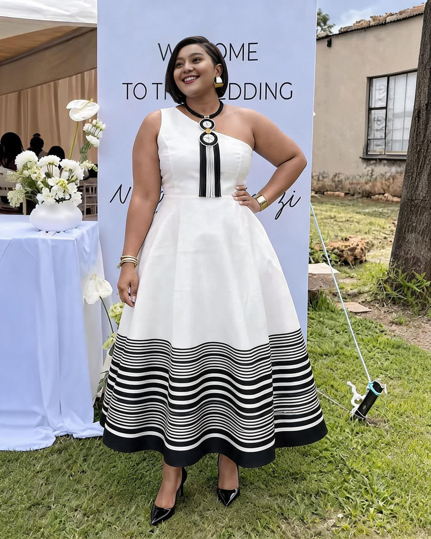 One-shoulder white midi dress with bold black striped hem and black vertical trim
