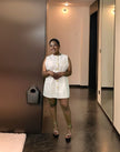 White belted sleeveless mini dress with button details and clean neckline, slim fit