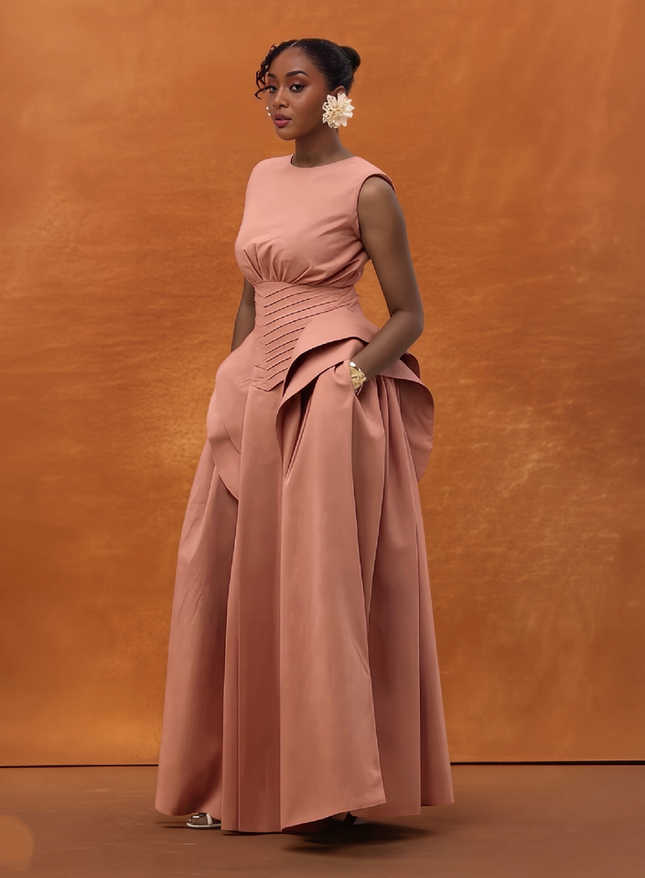 Blush sleeveless corset-waist maxi gown with ruched waist and full skirt