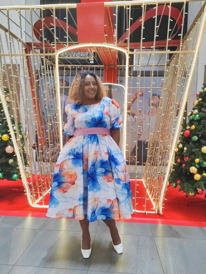 Blue floral midi dress with ruffle hem, tied waist, and puff sleeves