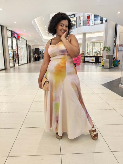 Gradient maxi dress with flowing skirt, spaghetti straps, pastel yellow to pink blend