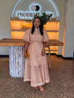 Peach midi dress with puff sleeves, front buttons, and a waist tie