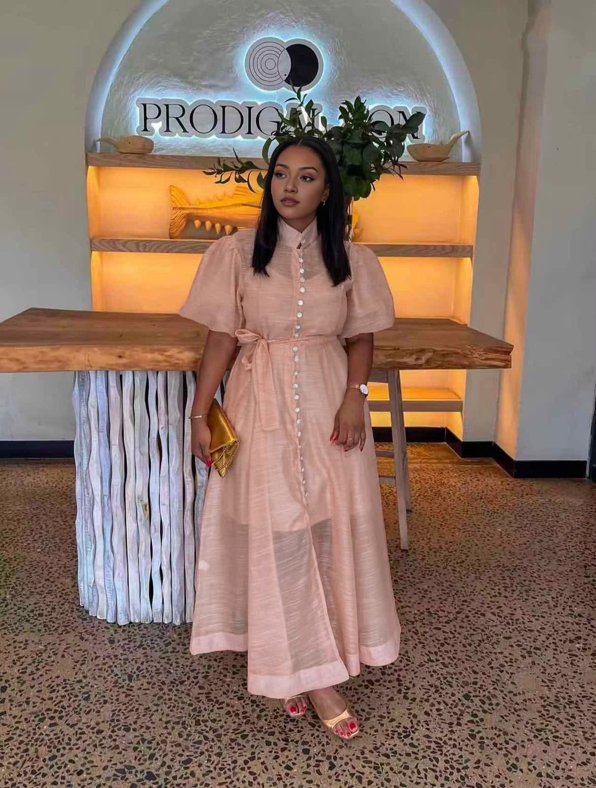 Peach midi dress with puff sleeves, front buttons, and a waist tie