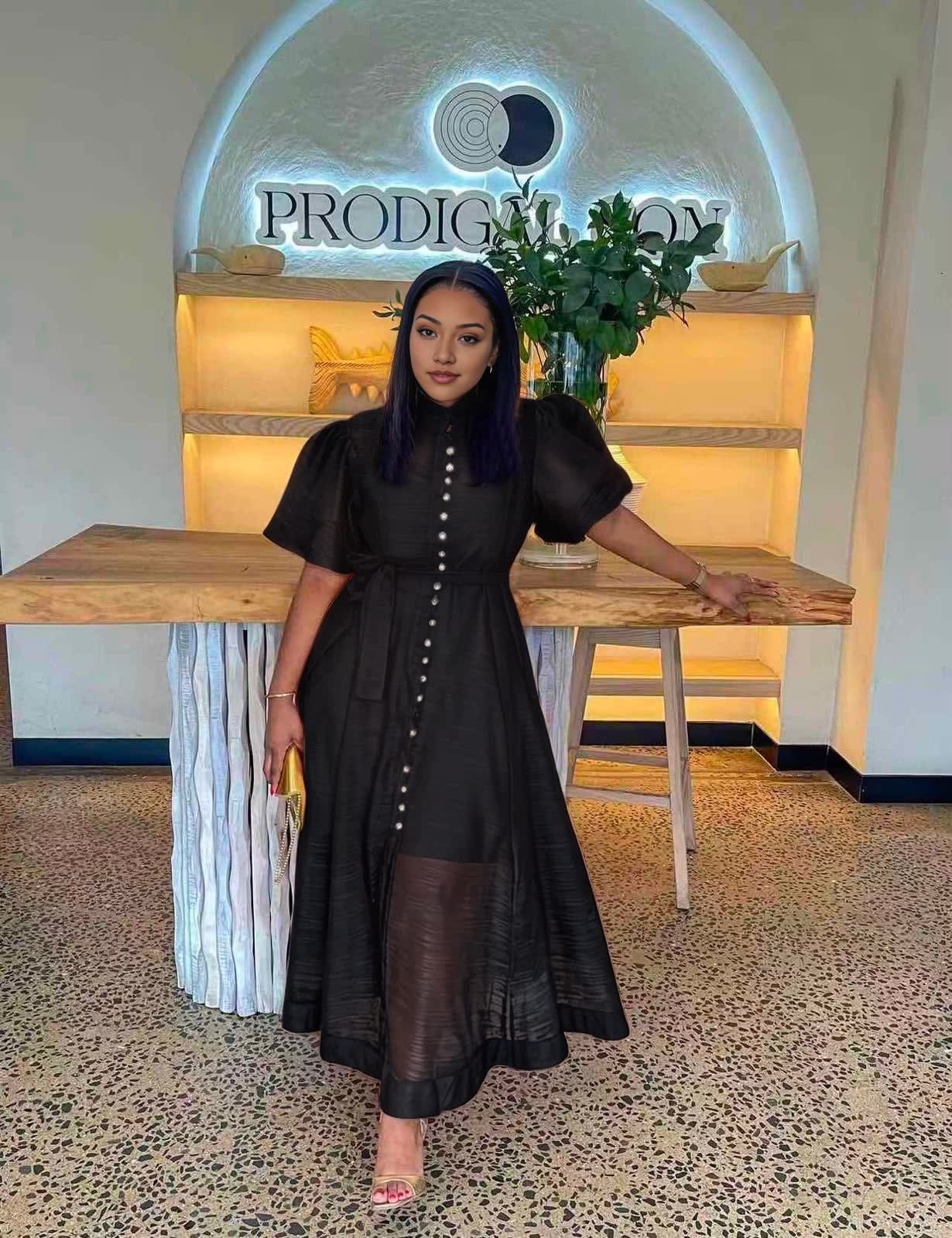 Black midi dress with puff sleeves, front buttons, and a waist tie
