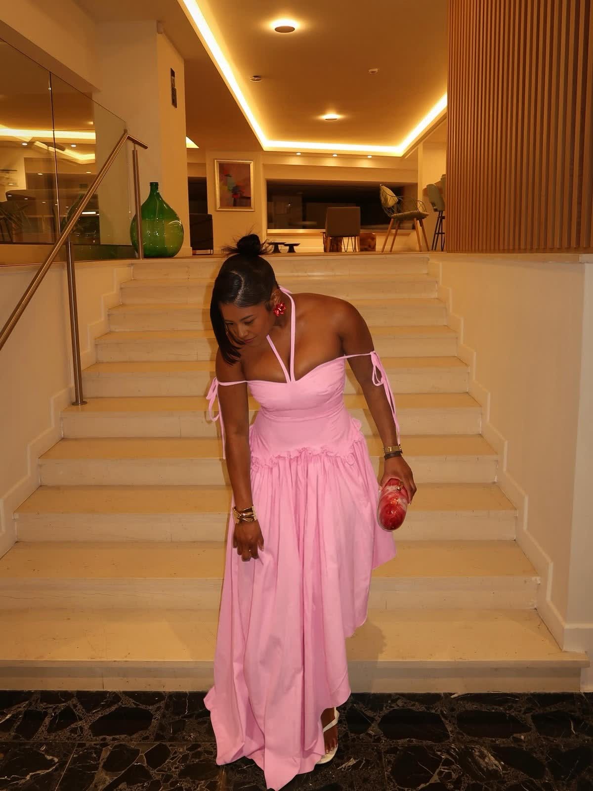 Pink halter-neck maxi dress with cold shoulders, tie straps, and a gathered waist