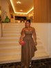 Brown halter-neck maxi dress with cold shoulders, tie straps, and a gathered waist