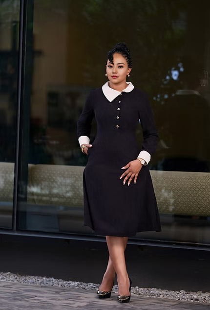 Black midi dress with white collar and gold button detail