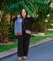 Black knit two-piece set with wide-leg loose pants and zip-front top
