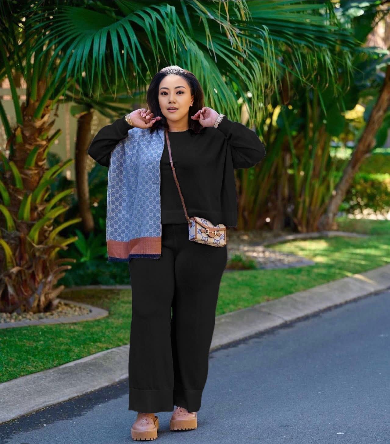 Black knit two-piece set with wide-leg loose pants and zip-front top