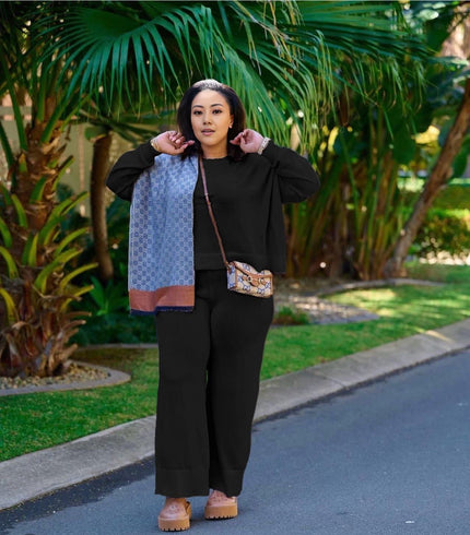 Black knit two-piece set with wide-leg loose pants and zip-front top