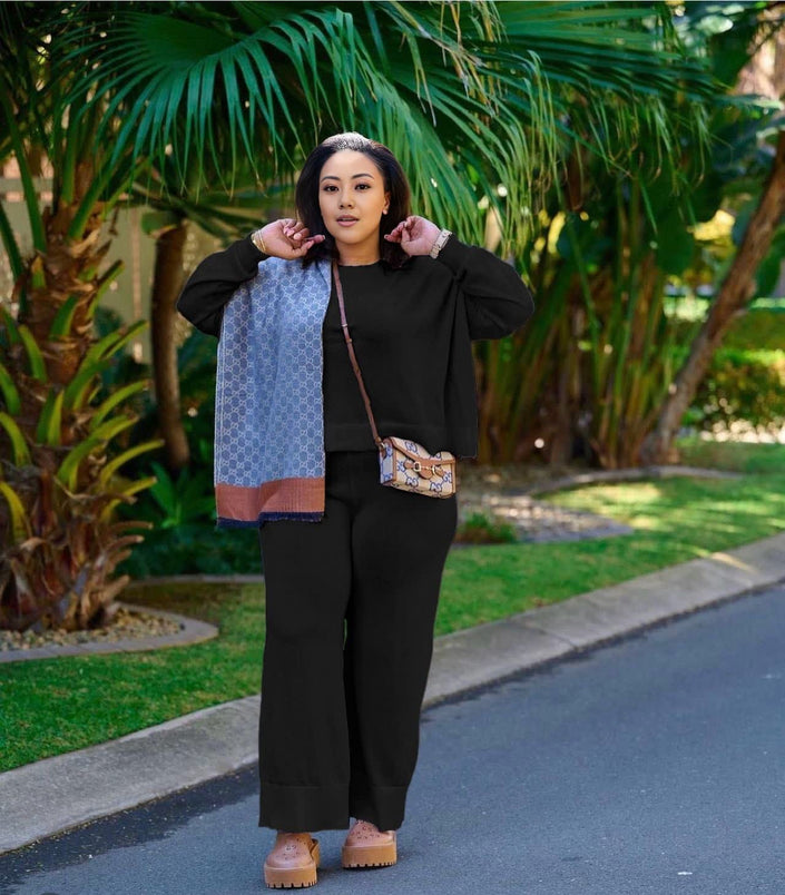 Black knit two-piece set with wide-leg loose pants and zip-front top
