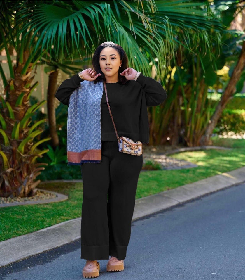 Black knit two-piece set with wide-leg loose pants and zip-front top