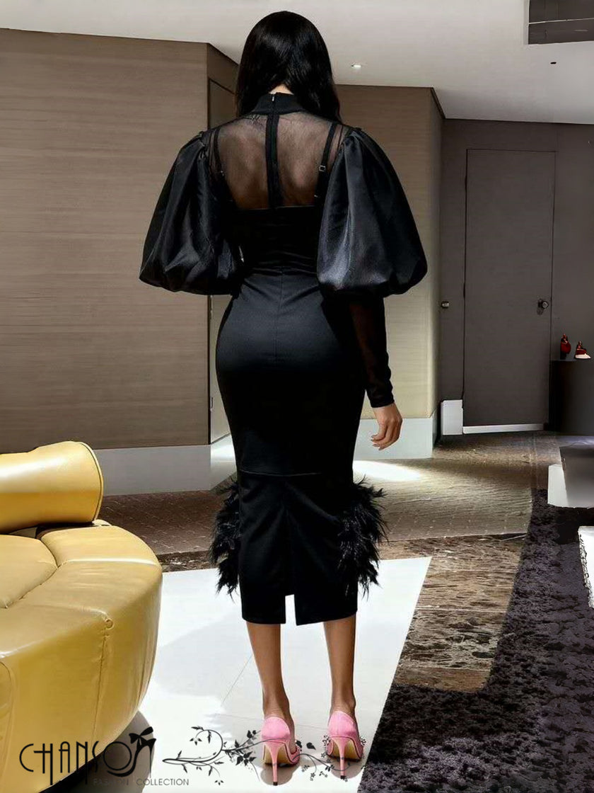 Black midi dress, back view, puff sleeves and feather hem detail
