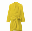 Yellow wrap mini dress with long sleeves, V-neck, and waist tie bow detail.