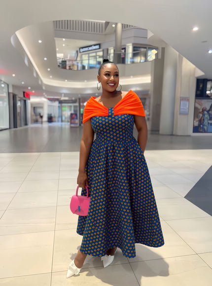 Blue off-shoulder midi dress with circular print and orange neckline detail