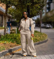 Nude zip jacket twin set with wide-leg stripe trousers and contrast band cuffs