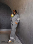 Grey zip jacket twin set with wide-leg stripe pants, striped cuffs and hem