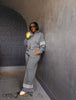 Grey zip jacket and wide-leg stripe pants set, full-length front zip, striped cuffs.